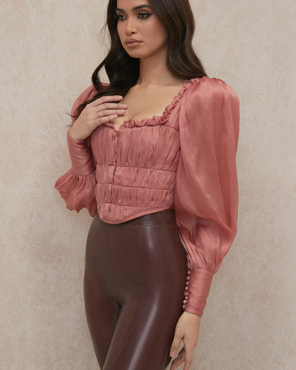 Rouge korset met lange mouwen en ruches